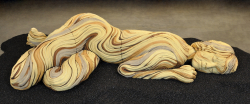 Large than life sized sleeping figure with bristlecone pine inspired textures. White stoneware and underglazes.